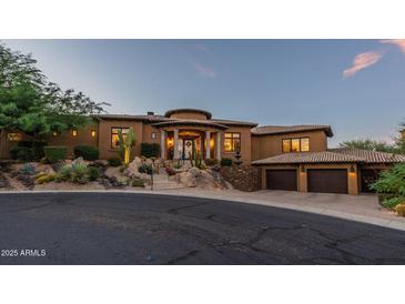 Stunning single-story home with porte-cochere, mature desert landscaping, and three-car garage at 10742 E Greythorn Dr, Scottsdale, AZ 85262