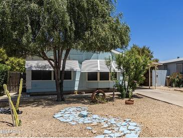 Ranch style home with mature trees and a gravel yard at 11275 N 99Th Ave # 9, Peoria, AZ 85345