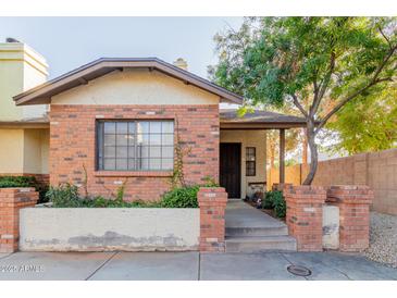 Brick home with a well-maintained front yard and walkway at 170 E Guadalupe Rd # 14, Gilbert, AZ 85234