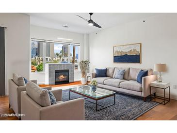 Bright living room with a modern fireplace and city views at 17 W Vernon Ave # 316, Phoenix, AZ 85003