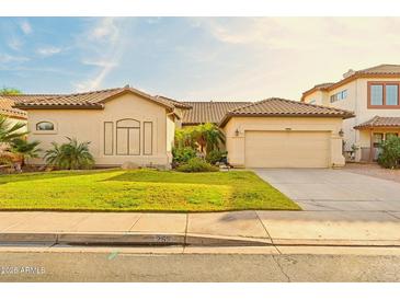 Charming single-story home featuring a tile roof, well-maintained lawn, and an attached two-car garage at 755 E Orchid Ln, Gilbert, AZ 85296