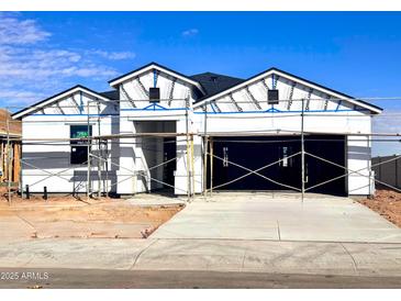 New construction home exterior; showcasing a two-car garage and modern design at 1562 E Mason Dr, Casa Grande, AZ 85122