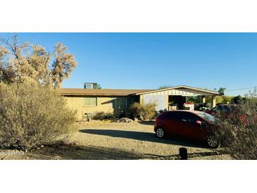 Ranch style home with carport and spacious yard at 1911 N 202Nd Ave, Buckeye, AZ 85396