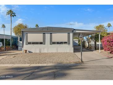 Mobile home exterior with carport and landscaping at 201 S Greenfield Rd # 205, Mesa, AZ 85206