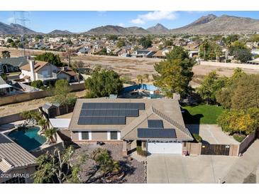 Aerial view of house with solar panels, pool, and desert landscape at 24444 N 40Th Ln, Glendale, AZ 85310