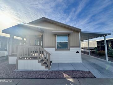 Tan and white single-wide manufactured home with covered porch and carport at 9333 E University Dr # 51, Mesa, AZ 85207