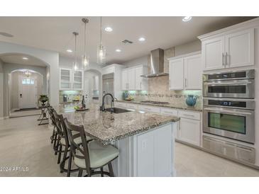 Spacious kitchen with granite countertops and stainless steel appliances at 1620 E Azafran Trl, Queen Creek, AZ 85140