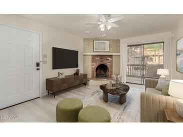 Bright living room featuring a fireplace and sliding glass door to balcony at 3031 N Civic Center Plz # 224, Scottsdale, AZ 85251