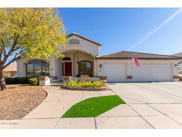 Beautiful single-story home with a landscaped front yard and two-car garage at 3121 S Verde Cir, Mesa, AZ 85212