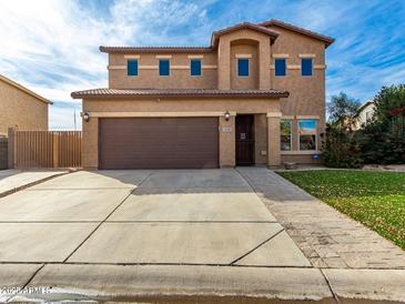 Two-story house with a large garage and well-manicured lawn at 319 E Palomino Way, San Tan Valley, AZ 85143