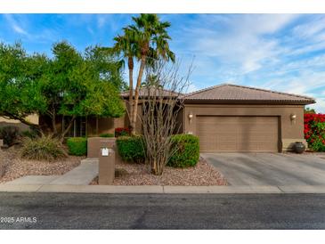 Single-story home with brown exterior, two-car garage, and landscaped yard at 3799 N 154Th Dr, Goodyear, AZ 85395