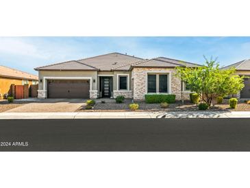 Single-story home with a two-car garage and well-manicured landscaping at 6659 N 127Th Dr, Glendale, AZ 85307