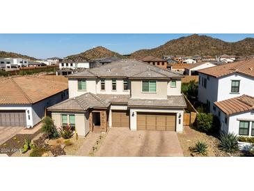 Two-story house with a three-car garage, desert landscaping, and mountain views at 7250 W Pinnacle Vista Dr, Peoria, AZ 85383