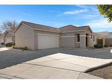 Tan house with a two-car garage and driveway at 931 S Porter Ct, Gilbert, AZ 85296