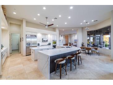 Gourmet kitchen boasts a large island, stainless steel appliances, and views to the backyard at 9771 E Roadrunner Dr, Scottsdale, AZ 85262