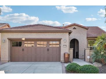 Single-story home with brown garage doors and landscaped front yard at 12951 W Andrew Ln, Peoria, AZ 85383