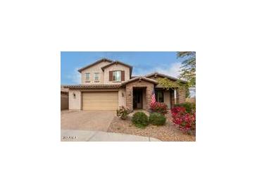 Two-story house with tan exterior, brown accents, and landscaping at 19544 W Lincoln St, Buckeye, AZ 85326