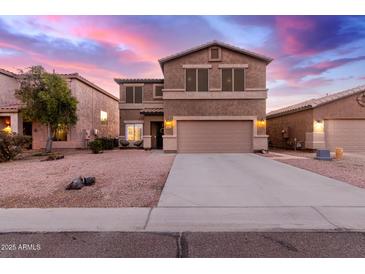 Two-story house with a large driveway and landscaped front yard at 30052 N Desert Willow Blvd, San Tan Valley, AZ 85143