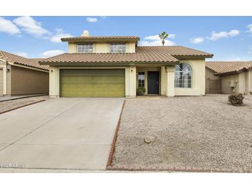 Charming home with a tile roof, two-car garage, and desert landscaping for easy maintenance at 4306 E Frye Rd, Phoenix, AZ 85048