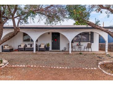 House exterior featuring a covered patio, seating area, and landscaping at 5546 W Encanto Blvd, Phoenix, AZ 85035