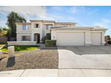 Two-story house with a three-car garage and landscaped front yard at 1021 E Mead Dr, Chandler, AZ 85249