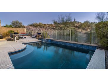 Inviting swimming pool with a spa and a beautiful desert landscape at 4742 S Primrose Dr, Gold Canyon, AZ 85118