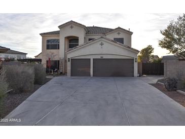 Two-story house with a three-car garage and landscaped front yard at 4913 W Pedro Ln, Laveen, AZ 85339