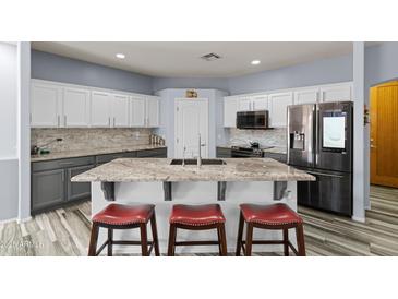 Spacious kitchen featuring granite countertops, stainless steel appliances, and an island with seating at 6131 S Eagle Pass Rd, Gold Canyon, AZ 85118