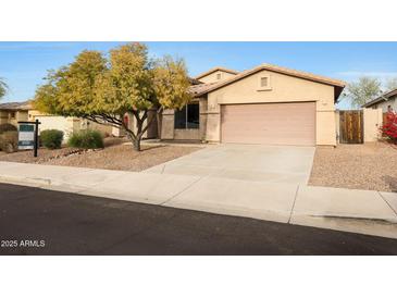 Single-story house with a two-car garage and desert landscaping at 10051 S 184Th Dr, Goodyear, AZ 85338