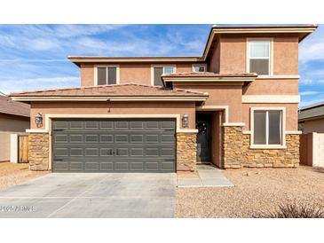 Two-story house with stone accents and a two-car garage at 24758 W Huntington Dr, Buckeye, AZ 85326