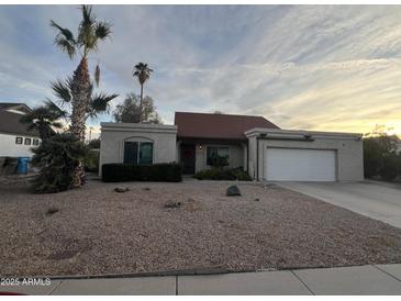 One-story house with red tile roof, attached garage, and desert landscaping at 4709 W Westcott Dr, Glendale, AZ 85308