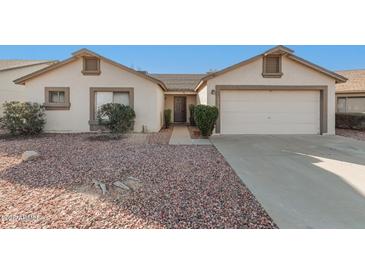 White single story home with two-car garage and landscaped front yard at 10831 W Laurie Ln, Peoria, AZ 85345