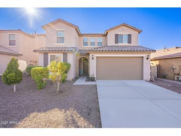 Two-story house with a two-car garage and landscaped front yard at 7067 W Maya Way, Peoria, AZ 85383