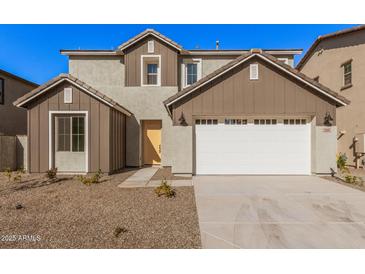 Two-story house with a white garage door and brown accents at 9242 E Sector Dr, Mesa, AZ 85212