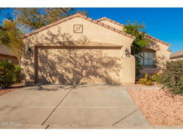 Single-story home with attached garage and desert landscaping at 1620 W Burgess Ln, Phoenix, AZ 85041