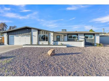 Charming single story home with gravel yard, two car garage and freshly painted white exterior at 2364 W Emelita Ave, Mesa, AZ 85202