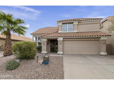Two-story house with tan exterior, tile roof, and landscaped front yard at 5951 E Trailridge St, Mesa, AZ 85215