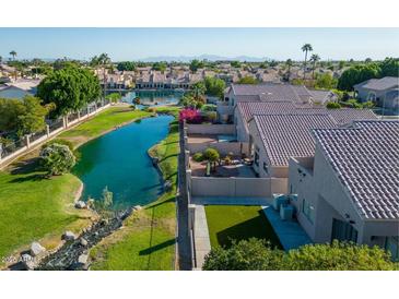 Aerial view of lakefront community with resort-style amenities and lush landscaping at 15091 N 90Th Dr, Peoria, AZ 85381