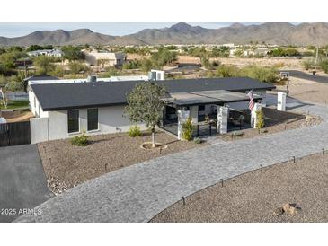 Single-story home with a modern design, paver driveway, and mountain views at 12524 E Saddlehorn Trl, Scottsdale, AZ 85259