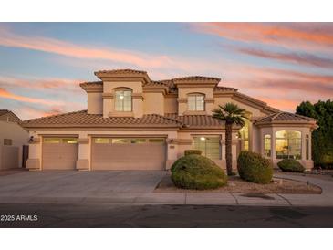 Two-story house with three-car garage and landscaped front yard at 1763 S Red Rock St, Gilbert, AZ 85295