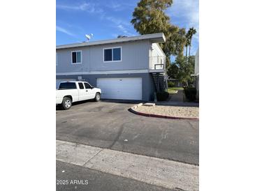 Gray duplex with attached garage and driveway, offering convenient parking at 2687 W Ocotillo Rd, Phoenix, AZ 85017