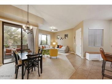 Spacious dining area with view of living room and access to balcony at 3330 S Gilbert Rd # 2090, Chandler, AZ 85286