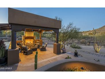Relaxing patio with fire pit and seating area at 6074 E Los Reales Dr, Carefree, AZ 85377