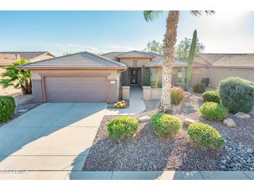 Single-story home with desert landscaping, two-car garage, and inviting entrance at 19425 N Guardian Ln, Surprise, AZ 85387