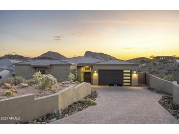 Beautiful desert home featuring a modern garage door, xeriscaping, tile roof and mountain views at 14828 E Valley Vista Dr, Fountain Hills, AZ 85268