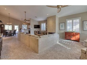 Spacious living room with vaulted ceilings, fireplace, and ample natural light at 3212 E Desert Cove Ave, Phoenix, AZ 85028