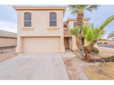 Two-story house with a large garage and mature palm trees in the front yard at 3555 S Payton St, Mesa, AZ 85212