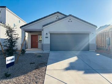 Newly built home with a two-car garage and desert landscaping at 5143 E Umber Rd, San Tan Valley, AZ 85143