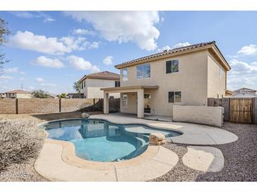 Inviting backyard with a sparkling pool and relaxing patio at 11706 W Shaw Butte Dr, El Mirage, AZ 85335