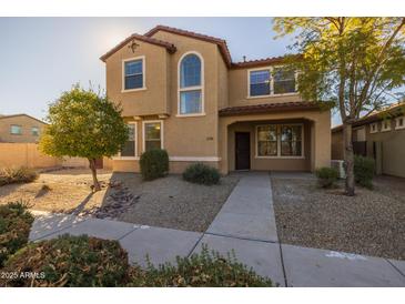 Two-story house with tan exterior, landscaped yard, and walkway at 1850 S Martingale Rd, Gilbert, AZ 85295